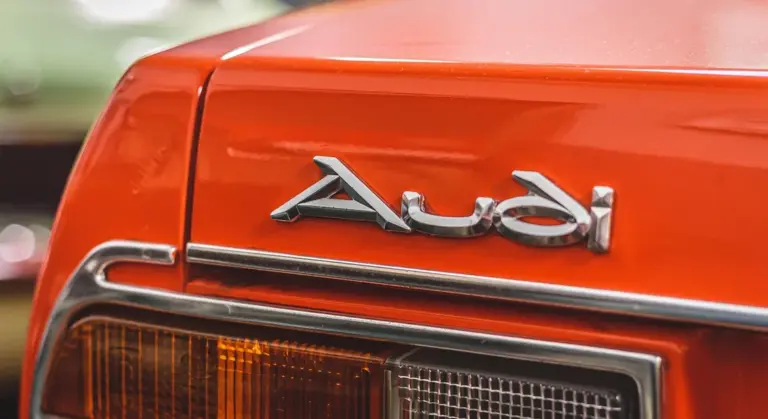 Close-up of an orange Audi rear panel with badge and taillight