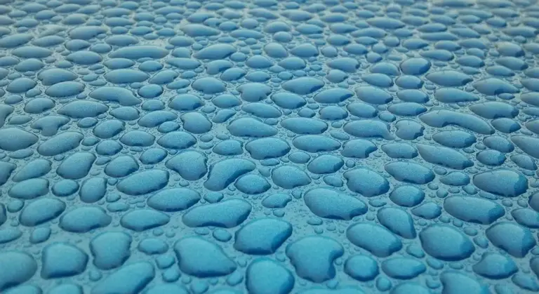 Close-up of a blue pebbled surface with rounded, smooth stones