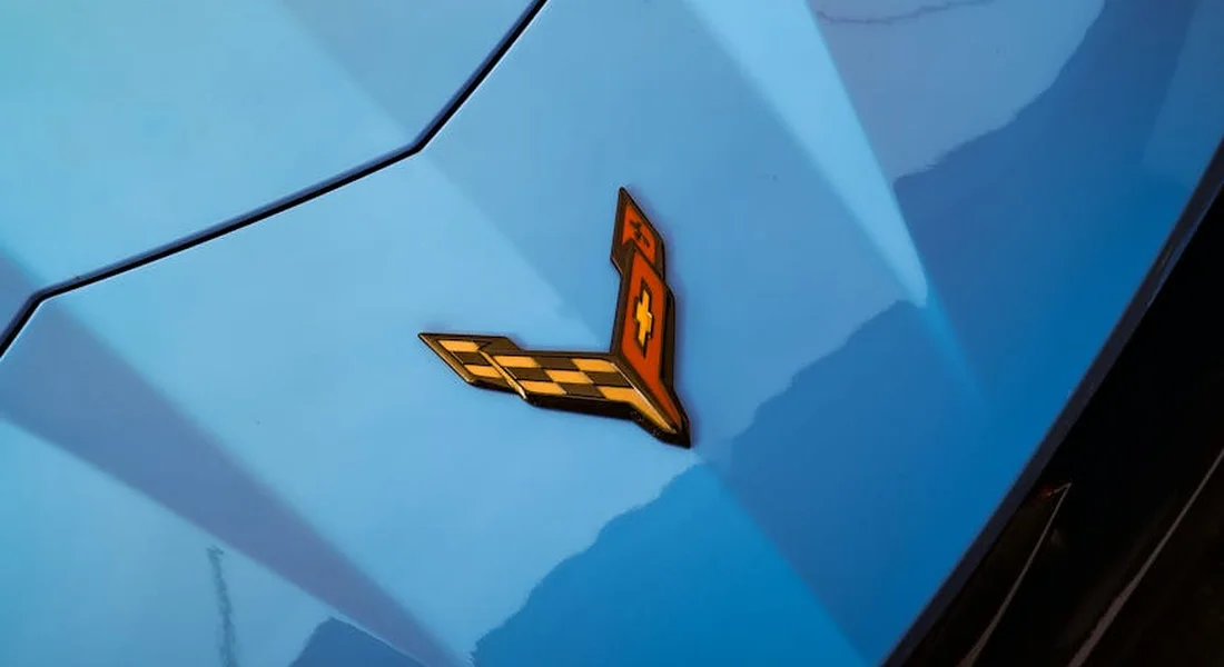 Close-up of a blue Corvette emblem on a car.