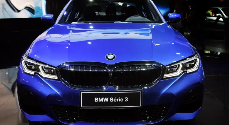 Front view of a blue BMW with a glossy bumper