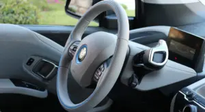 Close-up of a BMW car interior showing the steering wheel and dashboard