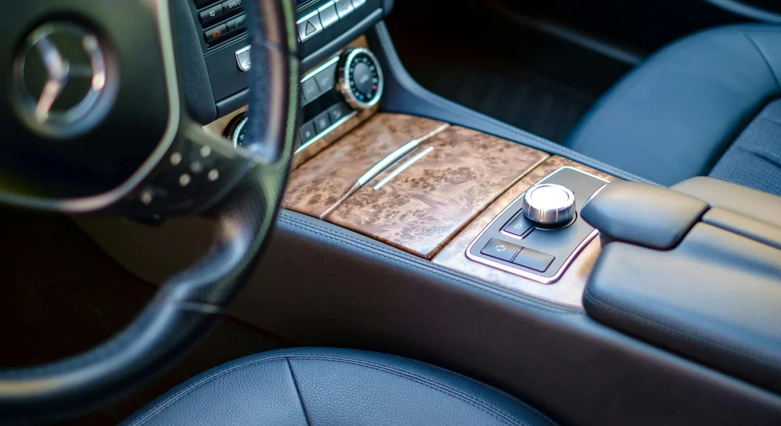 Close-up of a car's center console and leather seats, illustrating the vehicle interior where fresh pet urine might occur.