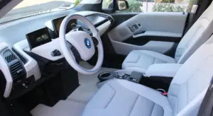 Interior of a modern car with light gray seats and dashboard, ready for spill-cleanup guidance.
