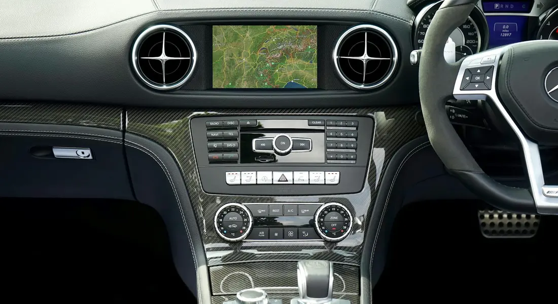 Luxury car interior focusing on the dashboard, navigation screen, and center console