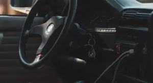 Interior of a car focusing on the dashboard and steering wheel, highlighting plastic surfaces that can get scratched.