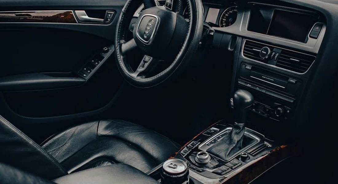 Interior of a car showing leather seats and center console, illustrating preparation for mold and mildew removal.