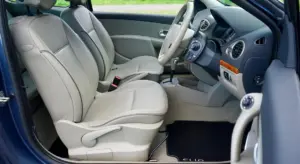 Inside a car showing beige leather seats and a clean console, illustrating leather upholstery.