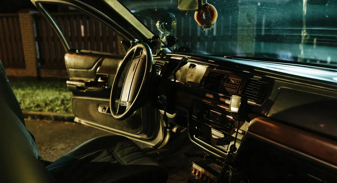 Interior of a car with the front seats and dashboard visible, illustrating cleaning and odor removal in vehicles.