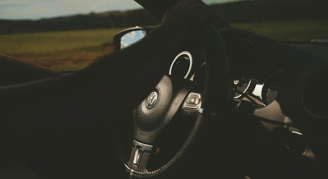 Close-up of a car interior showing the steering wheel and dashboard