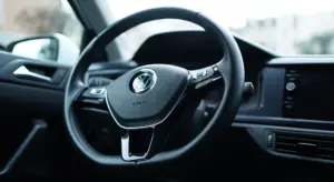 Close-up view of a car interior focusing on the steering wheel and dashboard
