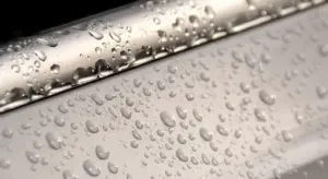 Close-up of water droplets beading on a car's painted surface