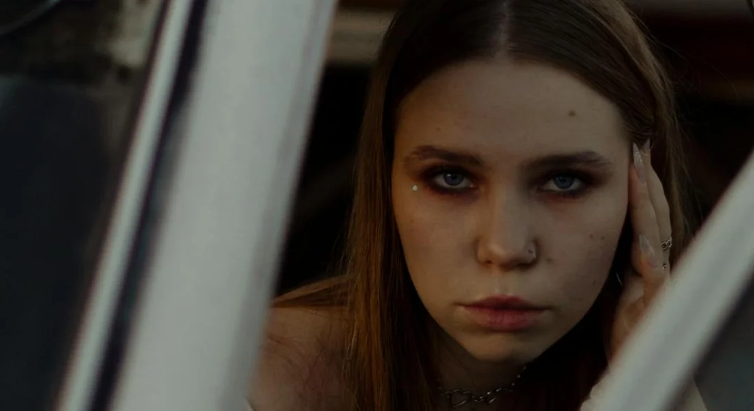 Person looking out from inside a car window.