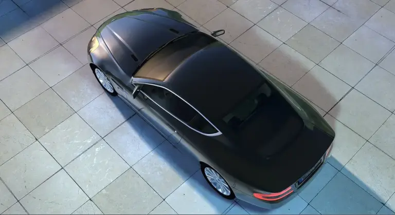 Top-down view of a black sedan on a showroom floor, highlighting paintwork and finish.
