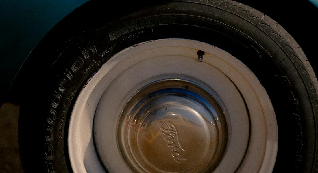 Close-up photo of a car wheel hubcap featuring a Ford emblem