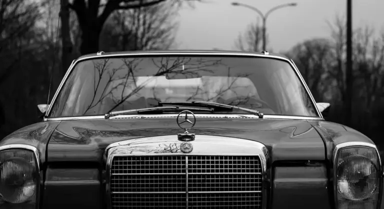 Front view of a classic black-and-white car emphasizing glossy paint and opportunities for color changes or special finishes.