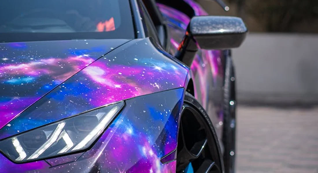 Close-up of a sports car with a vibrant galaxy-themed wrap
