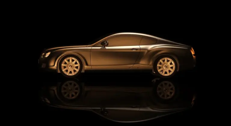 Side profile of a sleek gold-brown car with a glossy reflection on a black background