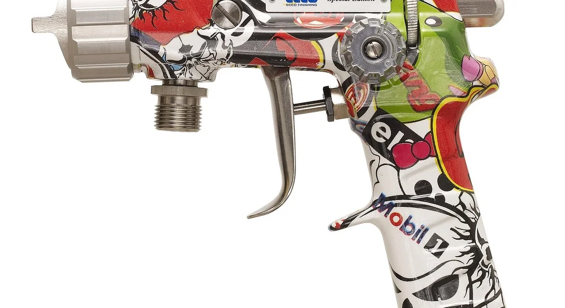 Colorful graffiti-painted automotive spray gun in profile