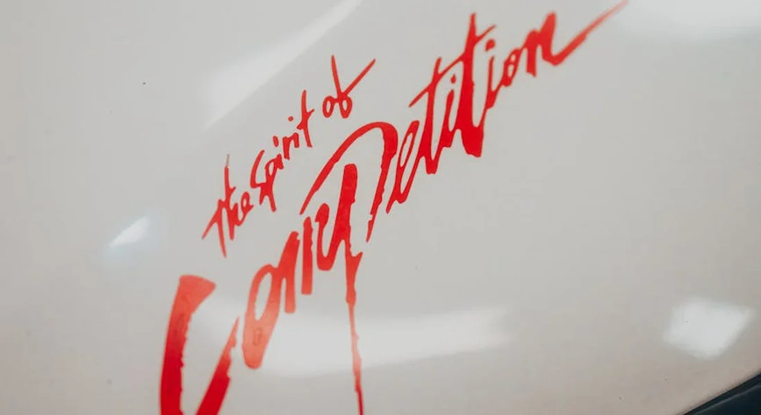 White car surface with bold red graffiti-style lettering that reads 'The Saint of Conception'.