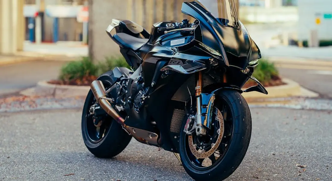 Black sport motorcycle parked on an urban street.