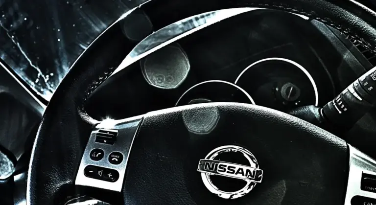 Close-up of a Nissan steering wheel showing the car interior