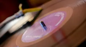 Close-up of a vinyl record spinning on a turntable with motion blur
