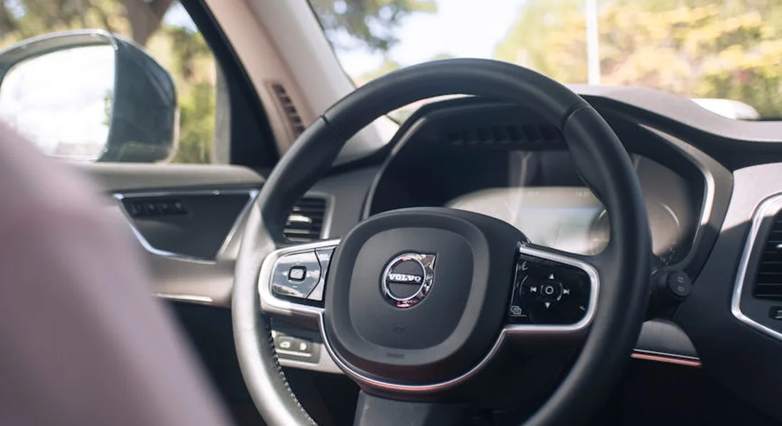 Close-up of a Volvo car steering wheel in a clean, modern car interior