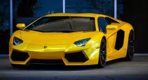 Bright yellow Lamborghini sports car parked outside a glass storefront